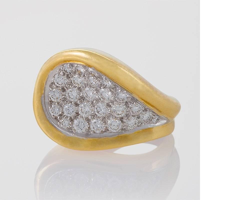 An English Mid-20th Century 18 karat gold and platinum ring with diamonds by Kutchinsky, London. The Modernist ring has 26 round platinum set diamonds with an approximate total weight of 1.60 carats, F/G color, VS clarity. The ring is designed in an