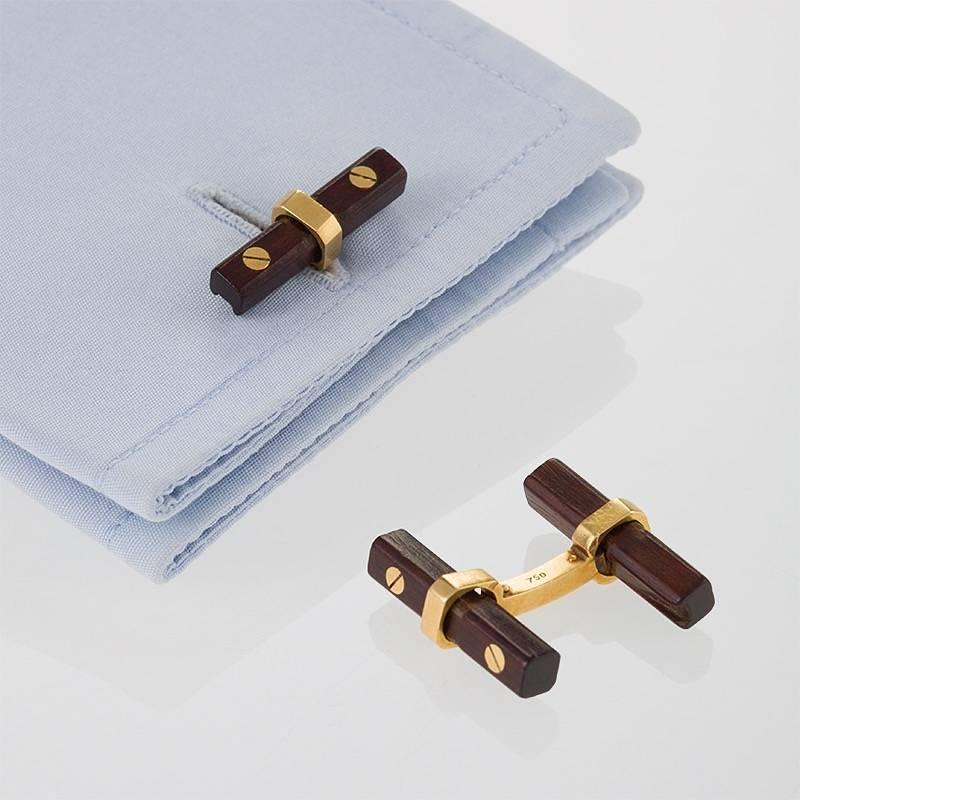 A pair of French Mid-20th Century 18 karat gold cuff links with wood by Van Cleef & Arpels. The cuff links have 4 interchangeable reeded wood batons with polished gold mountings.  Circa Mid-20th Century. 

Similar pictured in Cuff Links, by Susan