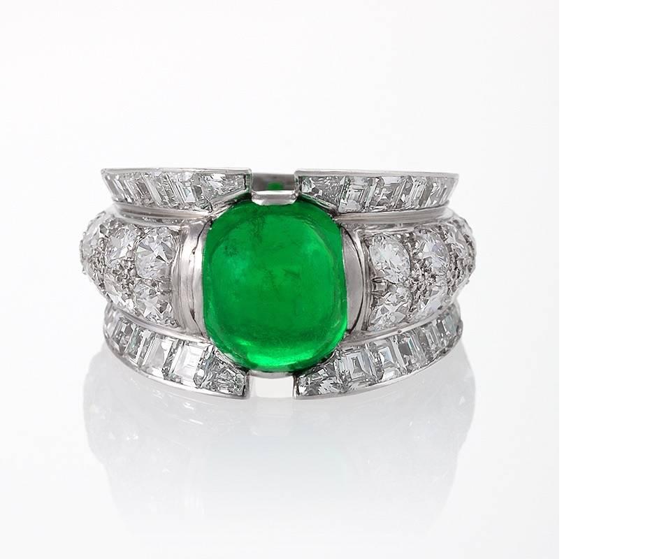 A French Late-20th Century 18 karat gold and platinum ring with emerald and diamonds. The ring has 18 round diamonds with an approximate total weight of 1.55 carats, 32 square-cut diamonds with an approximate total weight of 1.75 carats, and a