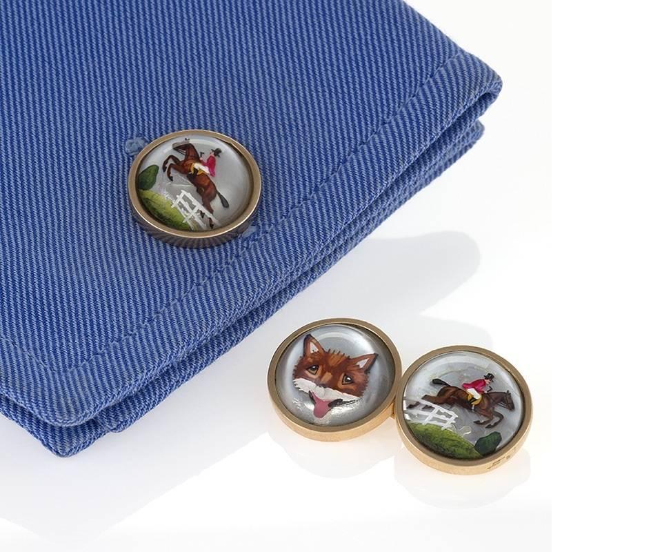 A pair of English estate 9 karat gold cuff links with carved crystals. The Essex crystal cuff links depict reverse painted fox and jumping horse with rider. The cuff links are double sided. Circa 1986. 

Essex crystals are clear crystal cut as a