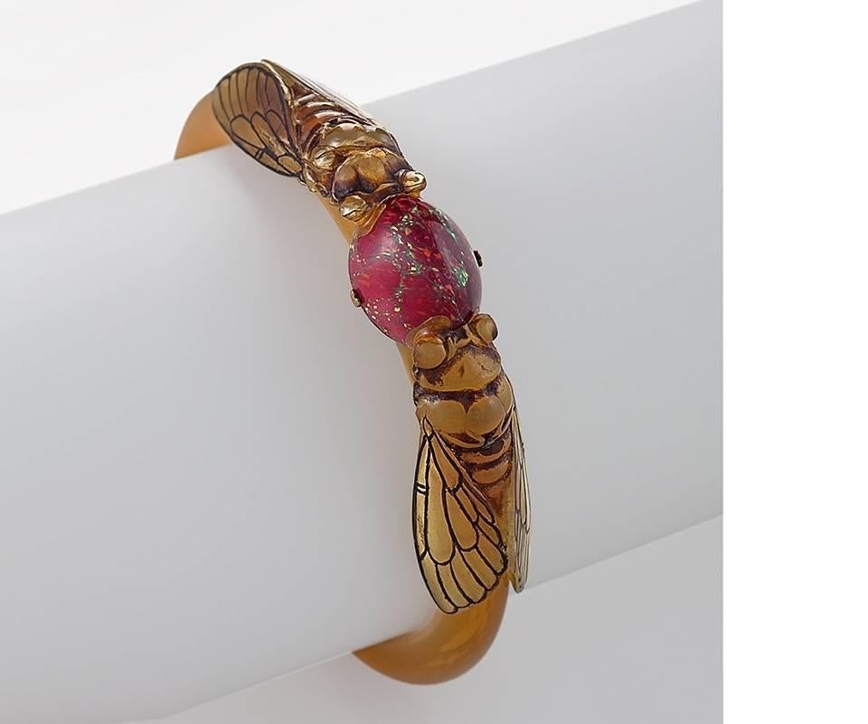 A French Art Nouveau horn bracelet with glass by Georges Pierre. The bracelet is composed of two facing cicadas separated by a glass cabochon on a natural horn bangle. Circa 1900. 

Discussed and similar pictured in Nature Transformed, by Macklowe