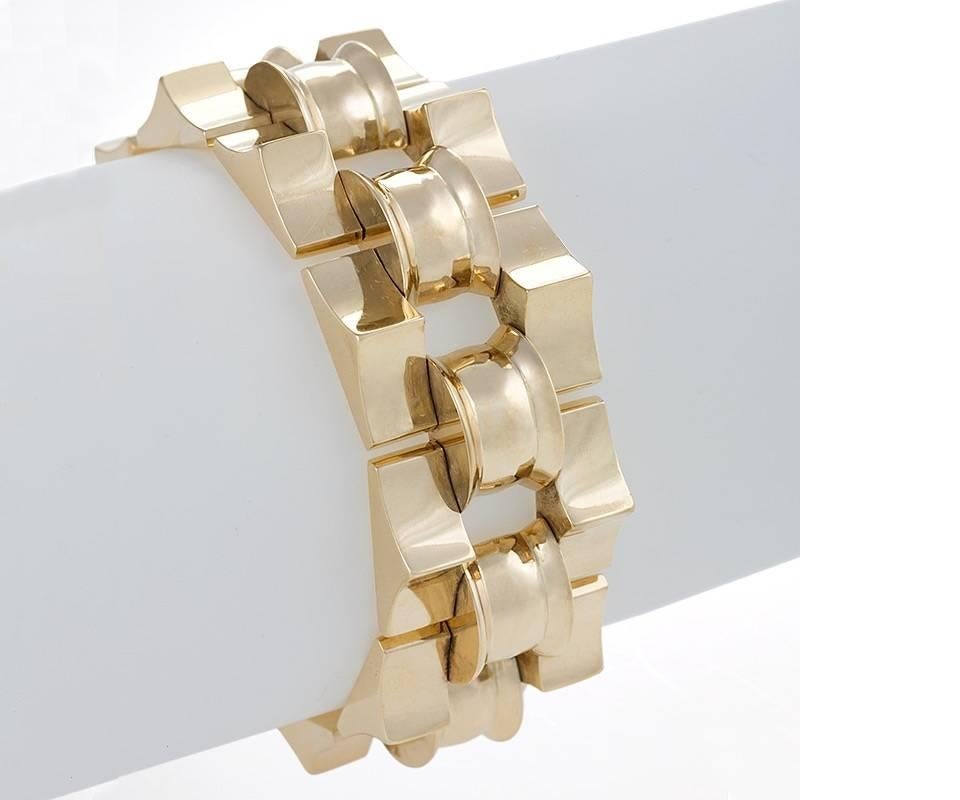 A Retro 18 karat gold bracelet composed of 10 three dimensional links connected by 10 half circle links. Circa 1940's. 

Following World War II, jewelry makers in Europe and America made heavy geometric link bracelets popular. Their inspiration