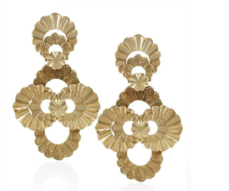 A pair of Late-20th Century 18 karat gold earrings.  The chandelier style earrings are composed of polished and textured scalloped gold overlapping rings.  The pendant elements of the earrings are articulated. Circa Late-20th Century.

(MG # 16876)