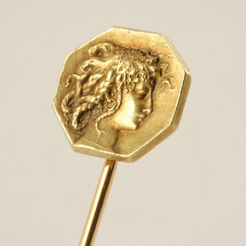 A French Art Nouveau 18 karat gold stick pin by René Lalique. The octagonal stick pin depicts a profile relief portrait of Medusa. Circa 1900. 

A sketch for a similar pin is pictured in: “René Lalique: Schmuck und Objets d’art, 1890-1910,