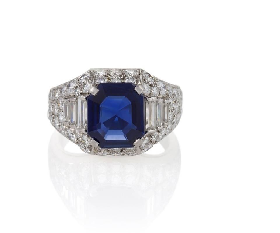 An Italian Late-20th Century platinum ring with sapphire and diamonds by Bulgari. The ring has a rectangular-cut sapphire with an approximate weight of 2.80 carats, and 58 round and baguette diamonds with an approximate total weight of 2.75 carats.