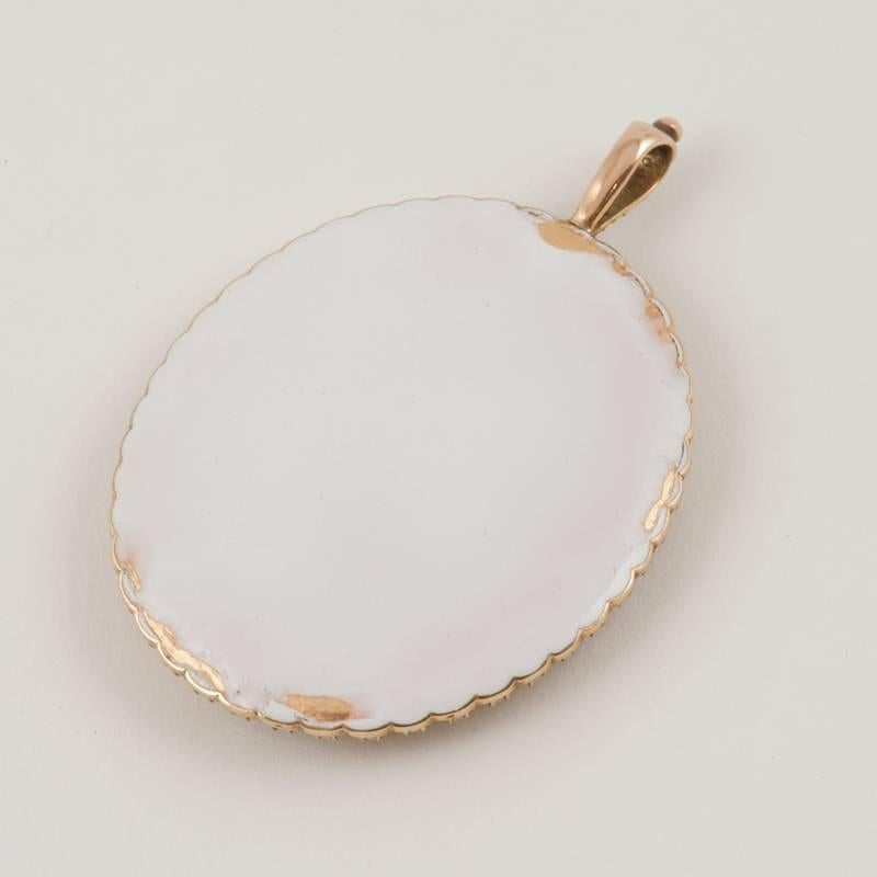 An English Georgian 18 karat gold and porcelain enamel Lover’s Eye pendant necklace with half pearls. The pendant necklace has 47 half pearls approximately 3 mm. in size surrounding the pendant. 
This unique pendant is composed of symbolic elements