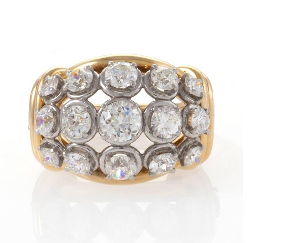 A French Retro 18 karat gold and platinum ring with diamonds by Van Cleef & Arpels. The ring features 15 old European-cut diamonds with an approximate total weight of 2.65 carats, H/I color, VS clarity.This ring is designed with  an open bombè