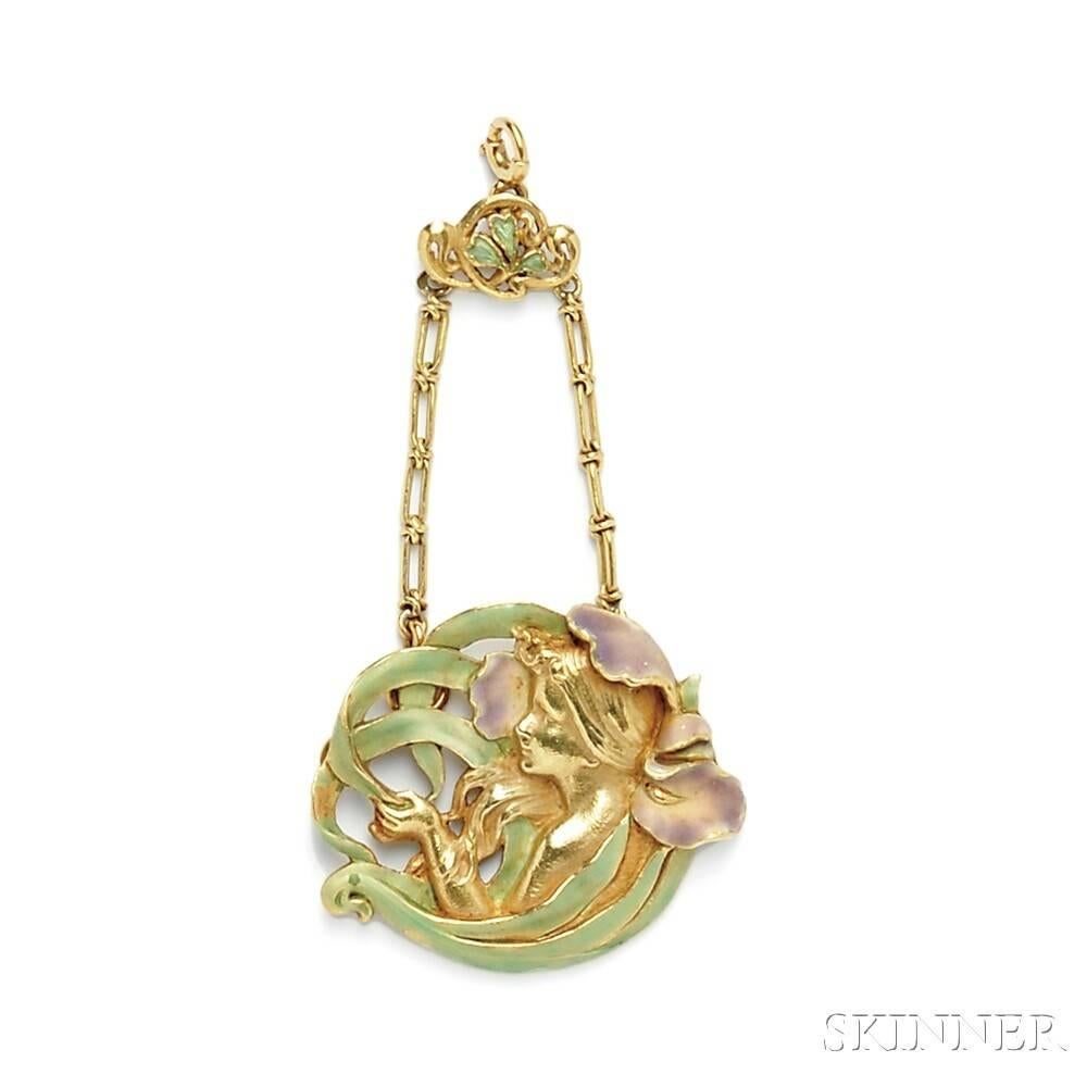 A French Art Nouveau 18 karat gold and enamel pendant by André Rambour. The pendant is designed as a maiden within an enamel iris which is suspended by fancy link chain and enameled foliate top. French control and maker’s marks. Circa