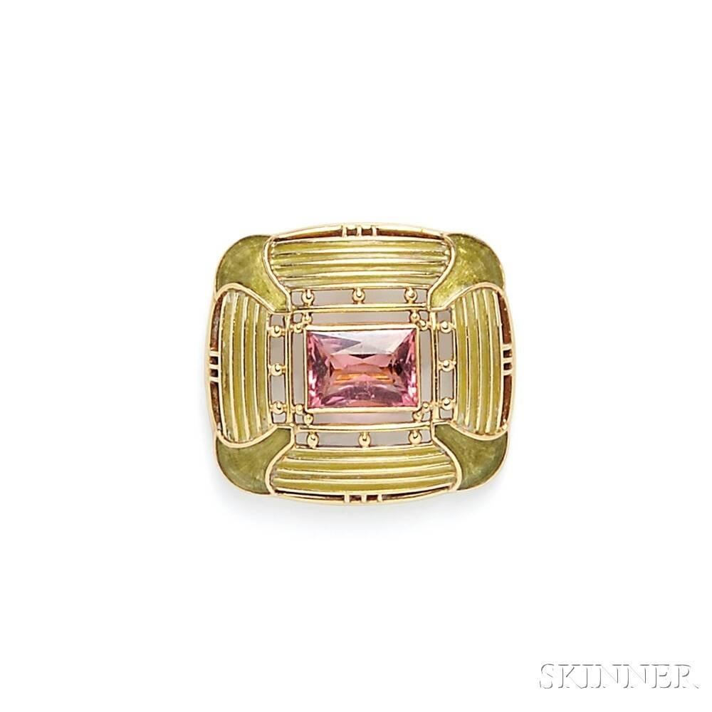 An Arts & Crafts plique-a-jour and enamel brooch with rubelite tourmaline by Louis Comfort Tiffany. The brooch has a bezel-set, fancy-cut rubelite tourmaline weighing approximately 4.40 carats, surrounded by a rectangular shaped plaque composed of