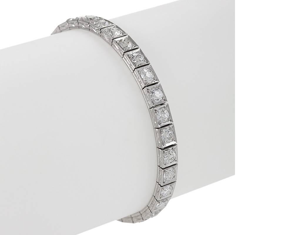 An Art Deco platinum bracelet with diamonds. The bracelet has 33 old European-cut and old Mine-cut diamonds with an approximate total weight of 6.60 carats, H/I color, VS-SI clarity. The diamonds are box set.  The platinum gallery is designed in a