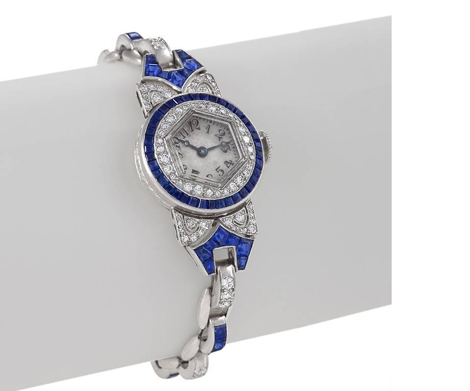 An American Art Deco platinum watch with diamonds and sapphires by Oscar Heyman. The watch has 93 round diamonds with an approximate total weight of 1.60 carats, and calibre and fancy cut sapphires with an approximate total weight of 3.60 carats. 