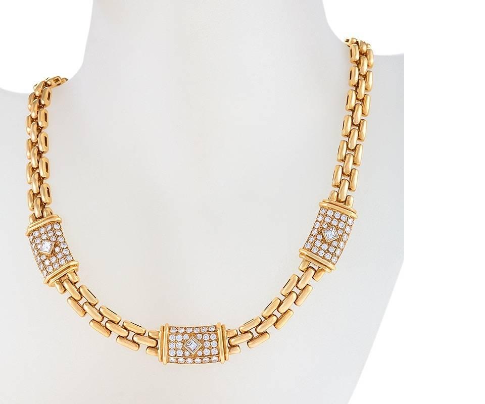 A French late-20th Century 18 karat gold necklace with diamonds by Cartier. The necklace has round and square-cut diamonds with an approximate total weight of 5.50 carats, which compose the three diamond set plaques on the brick chain necklace. The