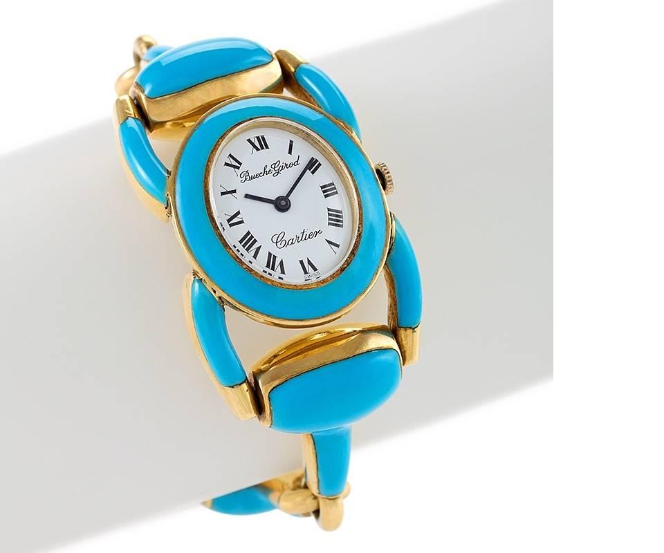 A Swiss Mid-20th Century enamel and gold watch by Cartier-Bueche Girod. The white oval face watch is integrated into a heavy turquoise enamel stirrup motif link bracelet. The face is signed Cariter and Bueche Girod. Mechanical movement. Circa