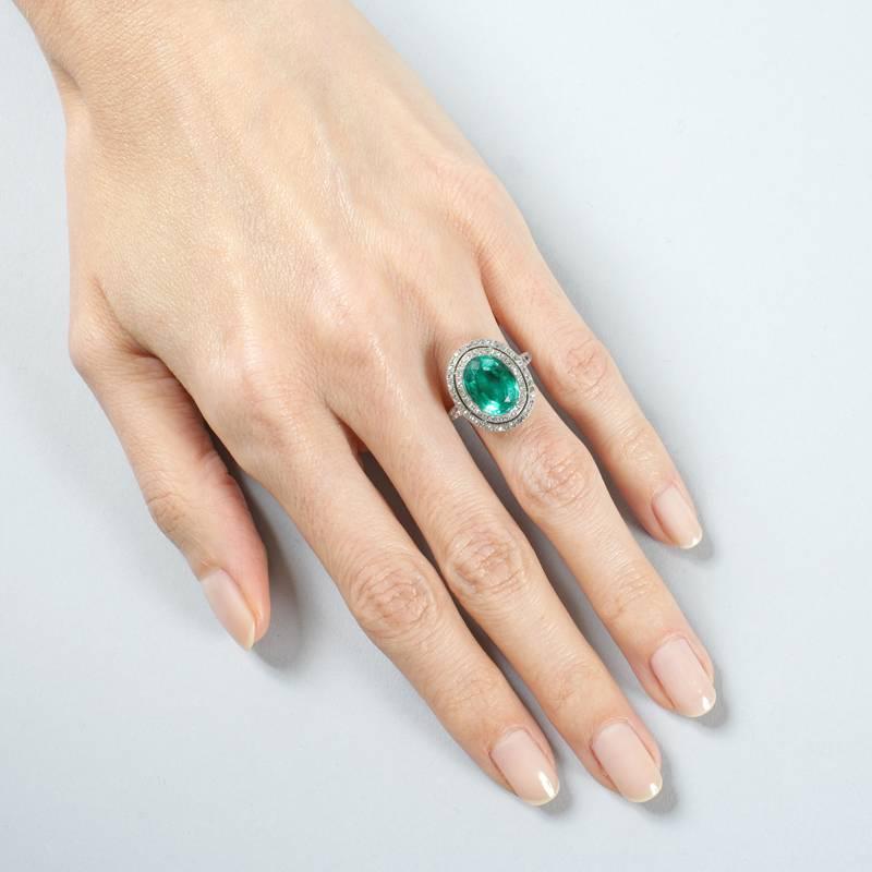 Oval Cut Colombian Emerald and Diamond Halo Ring  For Sale