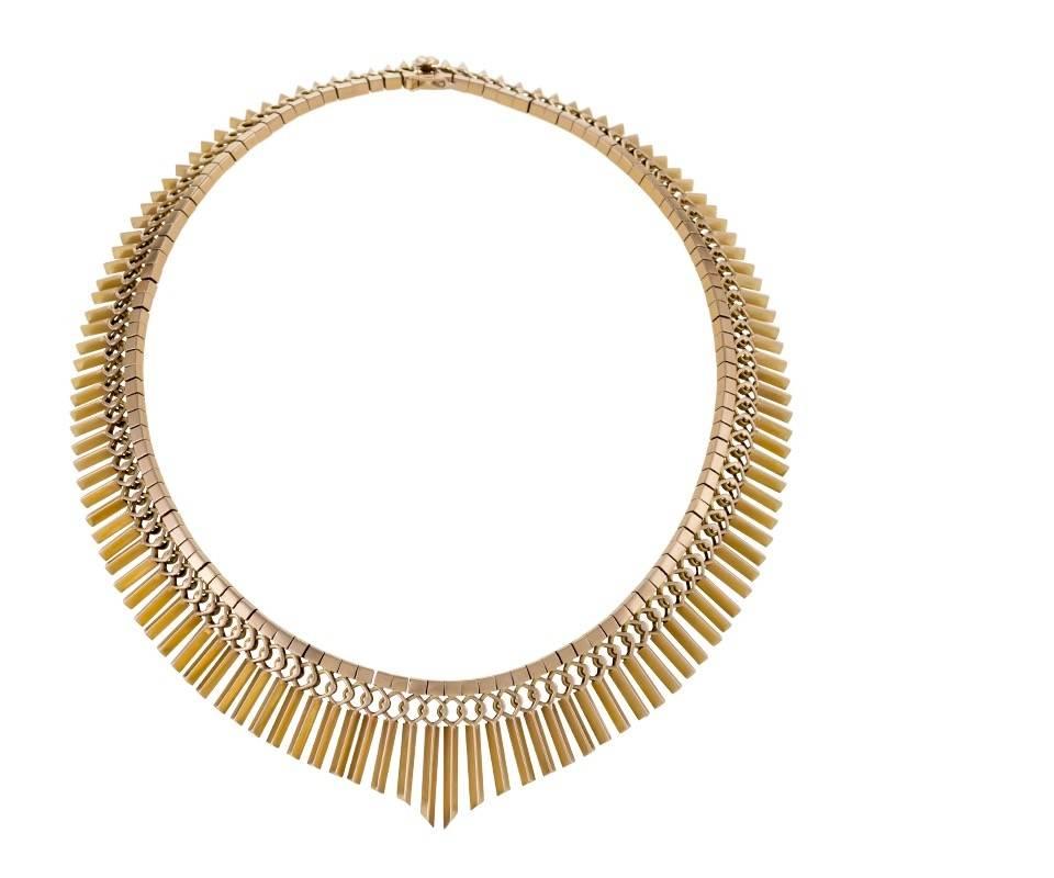 A European Mid-20th Century 18 karat gold necklace. The necklace is composed of graduated and articulated fringe which hangs from overlapping rings and a box link chain.  Circa 1950’s. 

Signed, “18k” “750”. 

(MG #16828)