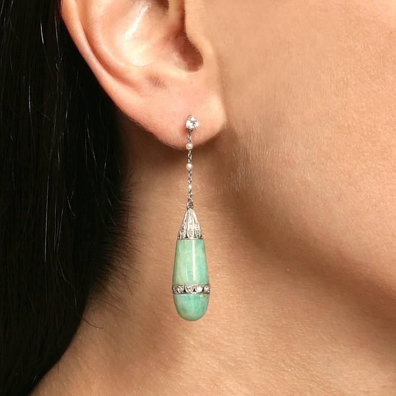 A pair of Art Deco platinum earrings with jadeite jade, diamonds and pearls. The earrings have jadeite jade drops, 42 rose-cut and Old European cut diamonds with an approximate weight of .62 carats, and 6 seed pearls. Circa 1920's.

“...earrings,