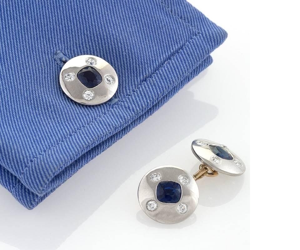 A pair of Art Deco 18 karat gold and platinum cuff links with sapphires and diamonds. The cuff links have 4 cushion-cut sapphires with an approximate total weight of 3.95 carats, and 16 old European-cut diamonds with an approximate total weight of