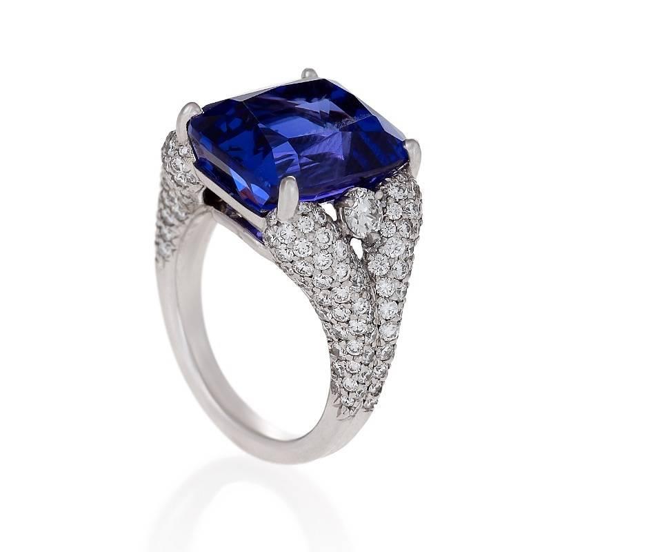 A Late-20th Century 18 karat white gold ring with tanzanite and diamonds by Henry Dunay. The ring has a cushion-cut tanzanite that weighs 13.42 carats in a diamond set white gold ring containing 166 round diamonds with an approximate total weight of