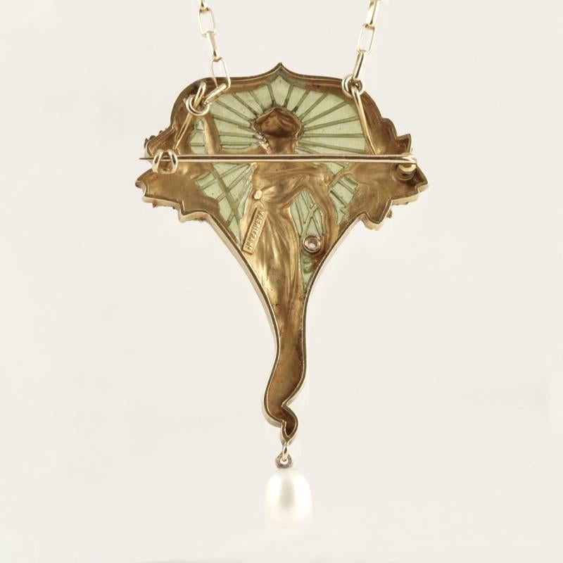 A Spanish Art Nouveau 18 karat gold pendant brooch with diamond and pearls by Masriera. The pendant/brooch has an old European-cut diamond with an approximate total weight of .07 carat, and a freshwater pearl drop of approximately 6 x 5 mm. The
