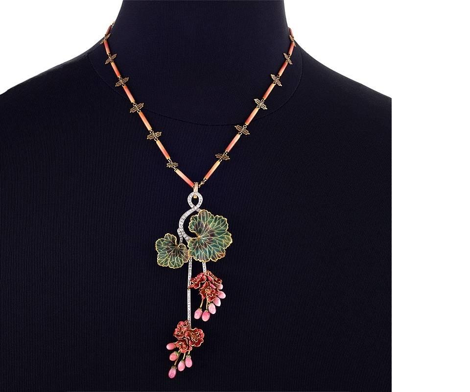 An Art Nouveau 18 karat gold plique-à-jour enamel ‘Morning Glory’ necklace attributed to Marcus & Co. The pendant has round diamond accents culminating in plique-à-jour flower clusters with 11 conch pearls. The detachable chain composed of