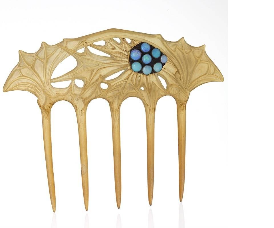 A French Art Nouveau horn and metal hair comb with opals by Lucien Gaillard. The blond hair comb has 8 cabochon opals decorating the thistle motif carving.  Circa 1900.

The making of Art Nouveau carved horn jewelry began in 1896 and peaked in the