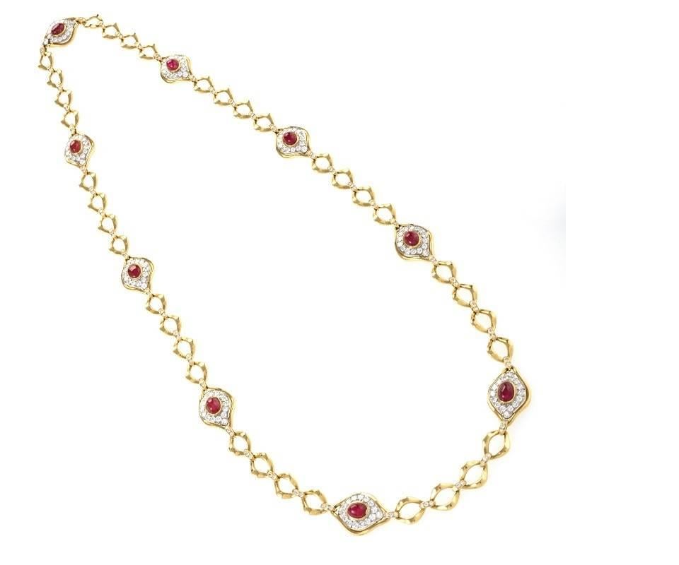 A French 18 karat gold and platinum long necklace with diamonds and rubies by O.J.Perrin Paris. This necklace contains 9 ruby and diamond plaques with  279 round cut diamonds including diamond links that connect the gold chain links. The diamonds