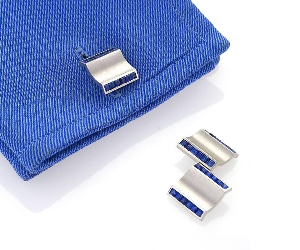 A Retro platinum and blue sapphire dress set that consists of a pair of double sided cuff links with 3 matching dress studs. There are 72 square cut blue sapphires with an approximate total weight of 3.75 carats. With box. Circa 1940’s. 

Signed,