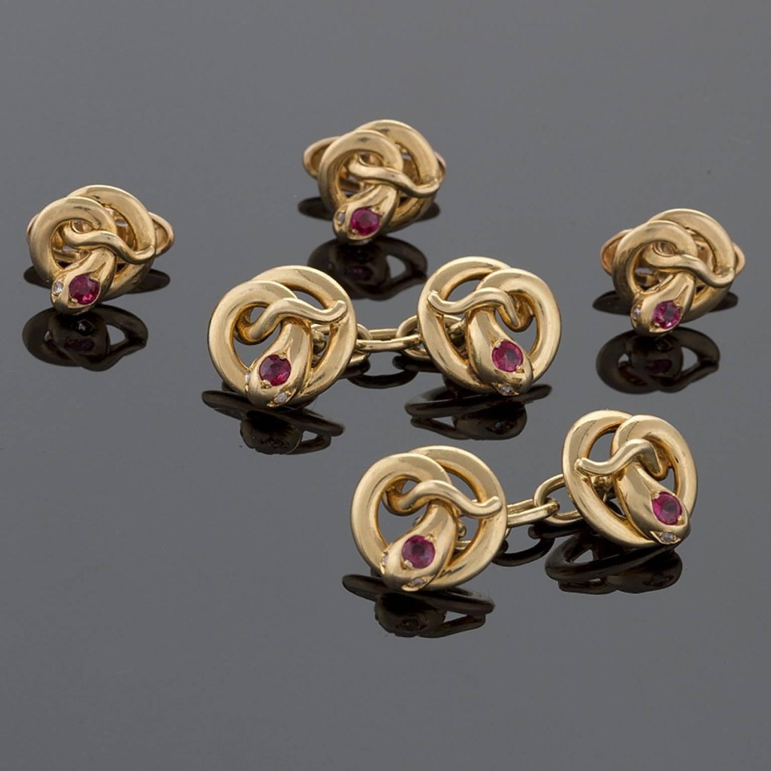 A French Art Nouveau 18 karat gold dress set with rubies. This dress set has double sided cuff links with 3 matching dress studs. The cuff links have 7 round-cut rubies with an approximate total weight of .35 carat. Original box, signed, 