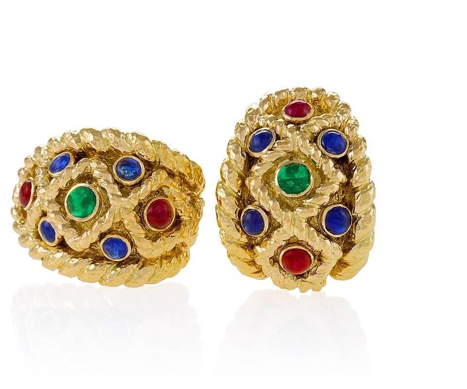 A pair of American 18 karat gold earrings with sapphires, rubies and emeralds by David Webb. The earrings have 8 cabochon sapphires with an approximate total weight of 2.40 carats, 4 rubies with an approximate total weight of 1.60 carats, and 2