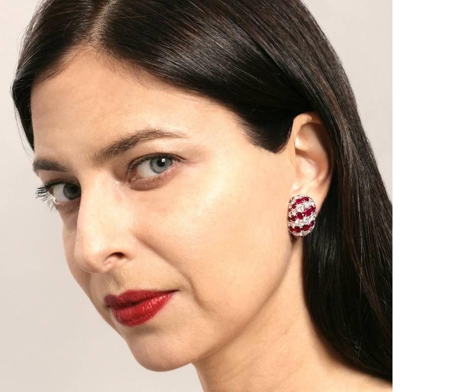 A demonstration of superlative artistry, this pair of French mid-20th century Van Cleef & Arpels clipback button earrings with stripes of rubies and diamonds is a masterpiece of modernism. With radiance that exceeds even their ideal proportions, the