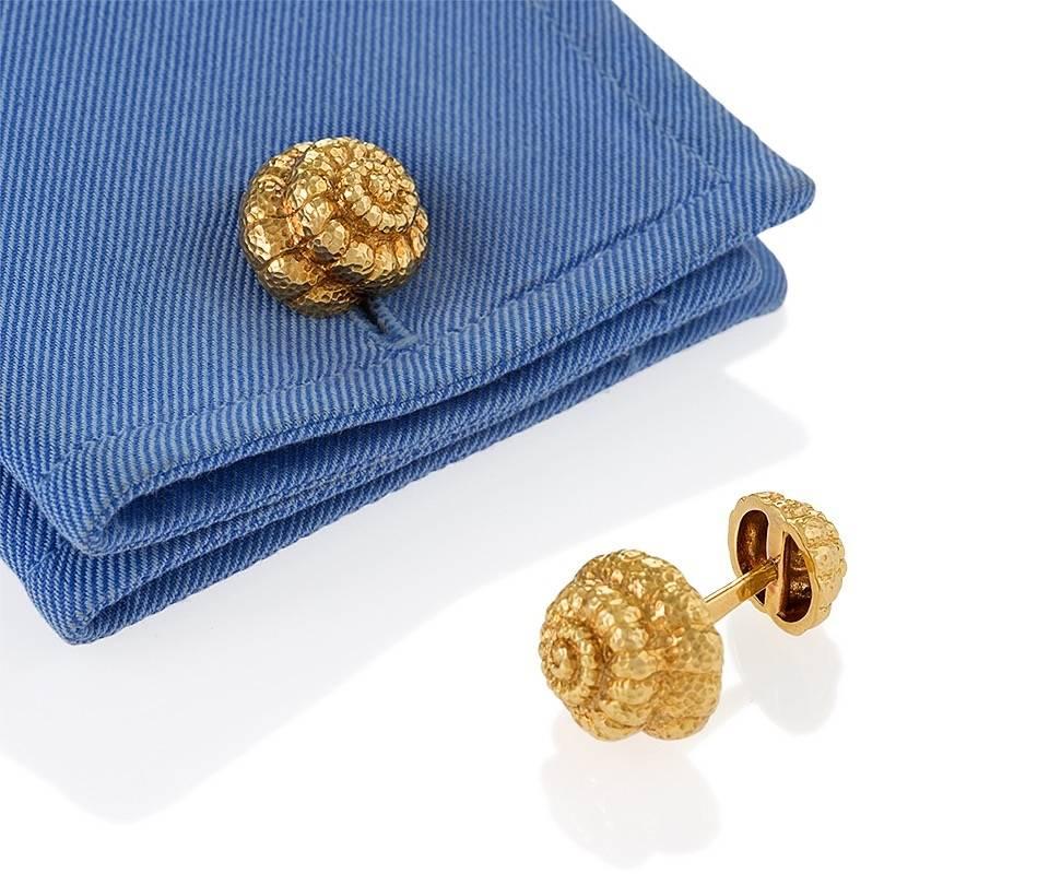 A pair of Late-20th Century 18 karat gold cuff links by David Webb. The dimensional cuff links are composed as sea shells, a larger top with smaller fixed back in textured gold. Circa 1970’s. 

Signed, Webb 18K. 

(MG #17139)