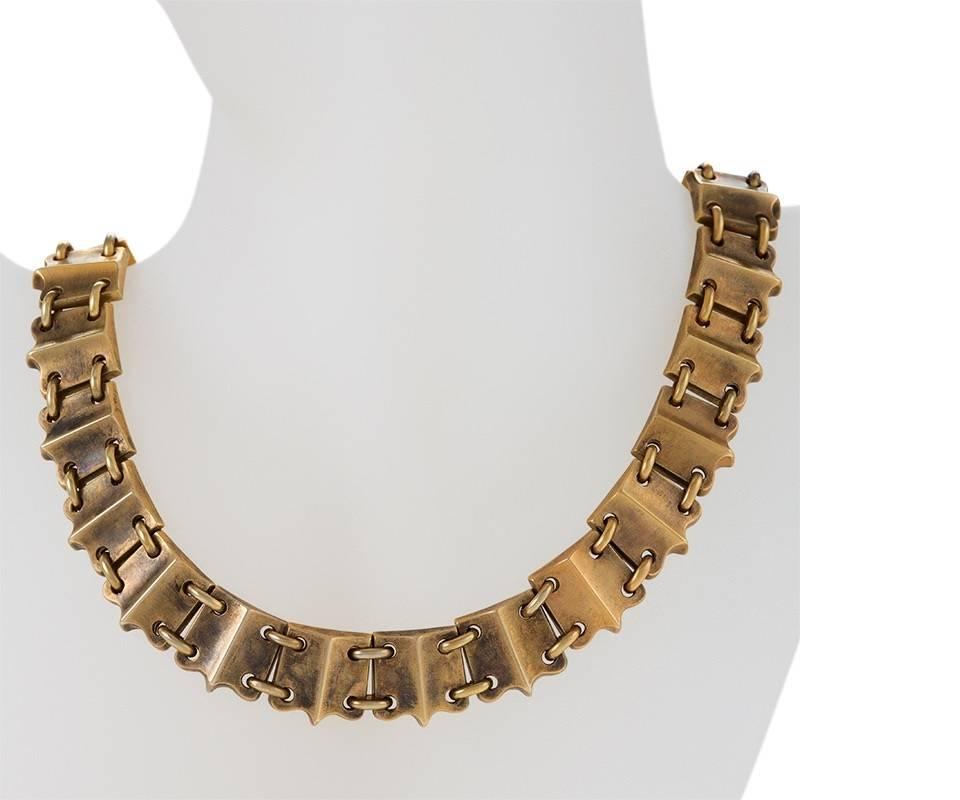 An English Victorian 15 karat gold necklace. The bloomed, flexible gold link necklace is composed of dimensional shield shaped sections with oval link connectors. Circa 1880.

(MG #17481)