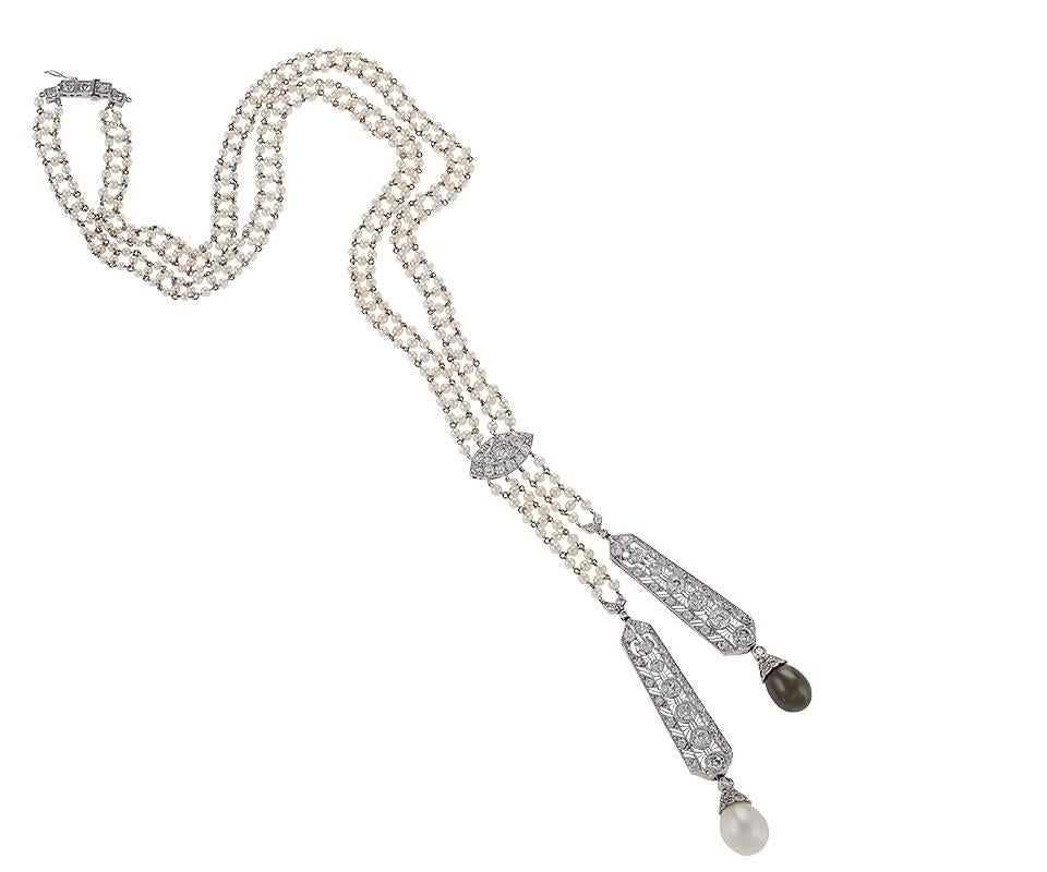 This glorious Art Deco double pendant necklace, with its asymmetrical natural pearl accents, harks back to the Ancien Régime style of “the negligée” jewel, meant to convey the wearer’s innate, careless elegance. This long antique necklace is the
