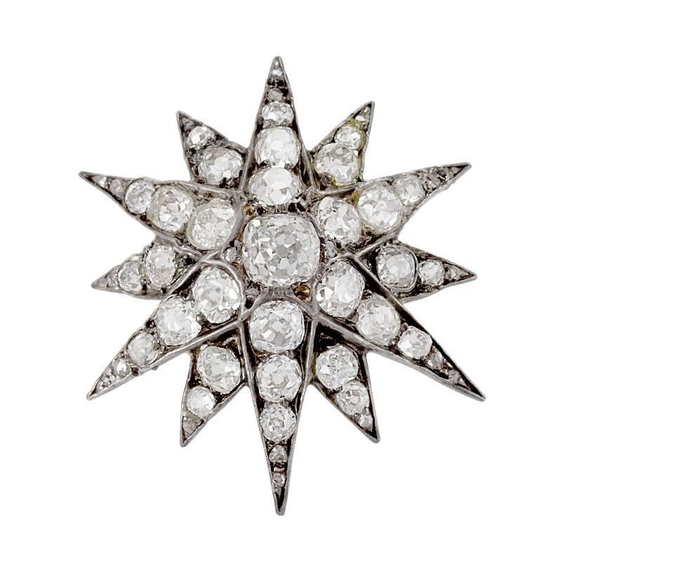 An English Antique silver top 15 karat gold brooch with diamonds. The brooch has 45 old mine-cut diamonds with an approximate total weight of 2.45 carats. With detachable gold brooch fitting. Circa 1880.

Stars were the most popular jewelry motif