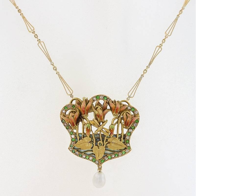A French Art Nouveau 18 karat gold pendant brooch with diamonds and emeralds. The pendant brooch has 23 rose-cut diamonds with an approximate total weight of .23 carat, and 23 old European-cut emeralds with an approximate total weight of .23 carat.