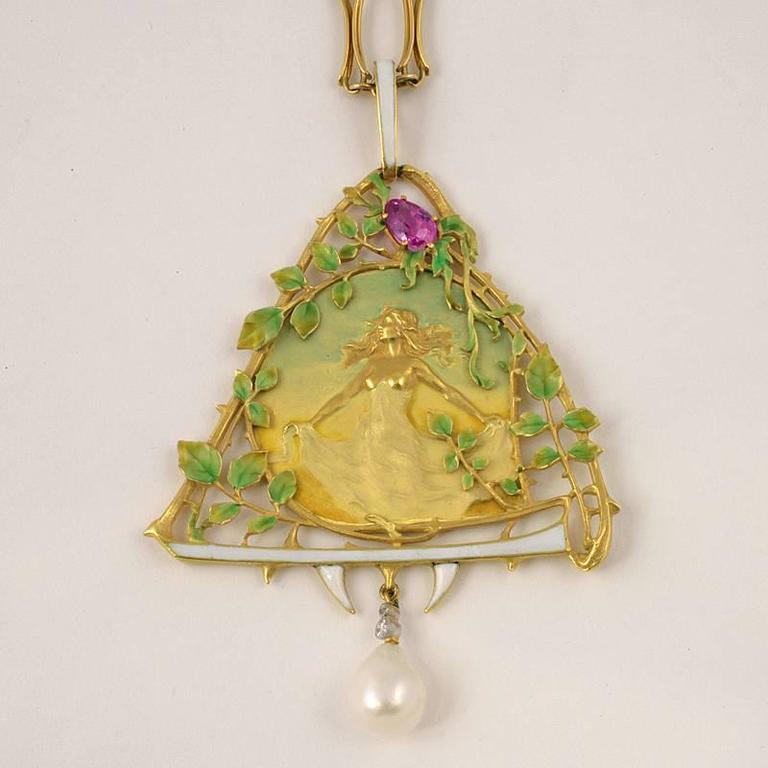 A French Art Nouveau 18 karat gold pendant with pink sapphire, diamonds and pearl by Lucien Gautrait. The pendant has a pear-cut pink sapphire with an approximate total weight of .80 carat, 2 old European-cut diamonds with an approximate total
