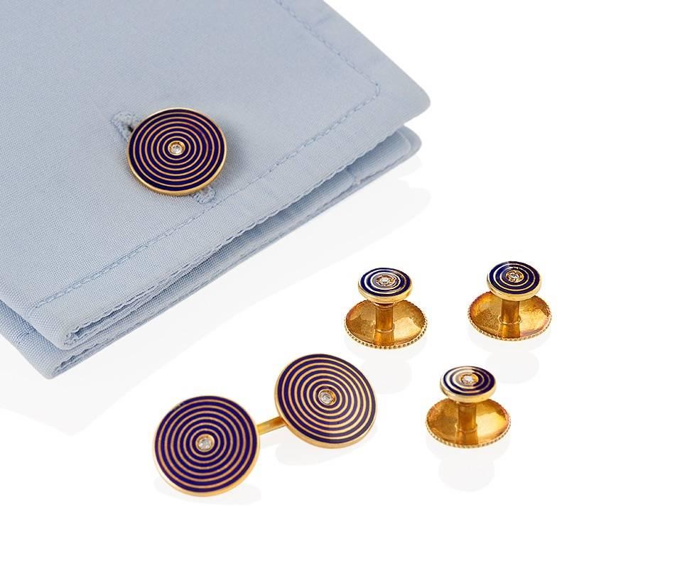 An English Late-20th Century 18 karat gold and enamel dress set with diamonds by Tiffany & Co. The dress set has 7 round diamonds with an approximate total weight of .18 carat. The double sided cuff links are decorated with concentric navy blue