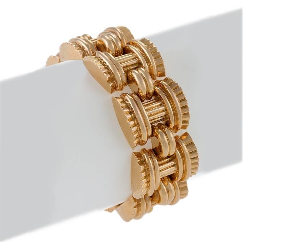 A French Late 1940's 18 karat gold bracelet by Vallienne Paris. The bracelet is composed of 9 'basket weave' flexible textured links.   Circa late 1940's-1950's.

Following World War II, jewelry makers in Europe and America made heavy geometric link