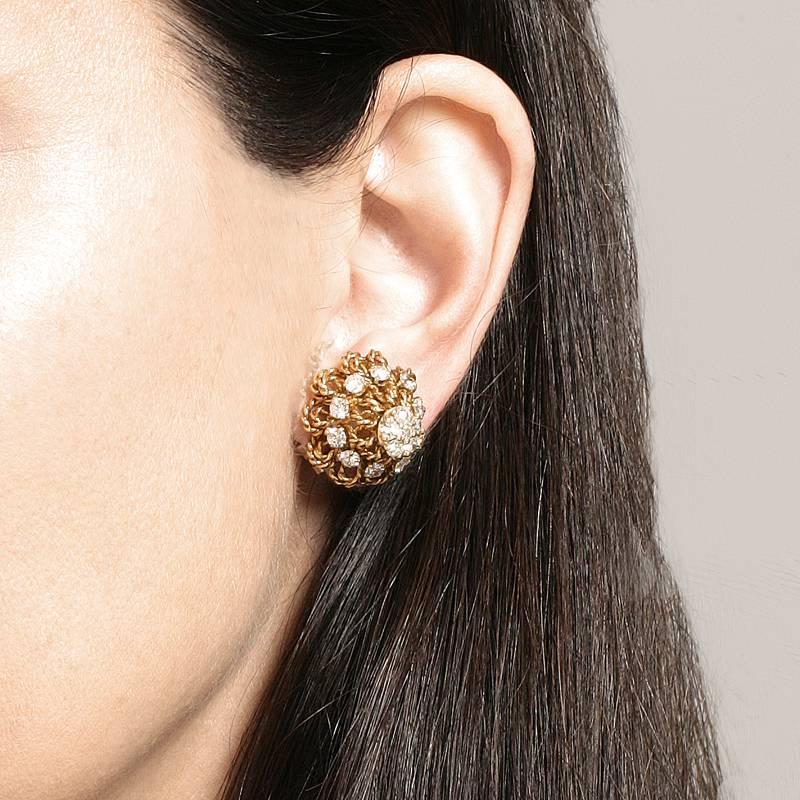 A pair of 18 karat gold earrings with diamonds by Marianne Ostier. The earrings contain 32 round-cut diamonds with an approximate total weight of 2.60 carats, G/H color, VS clarity. The earrings are composed of twisted gold wire forming a cone shape