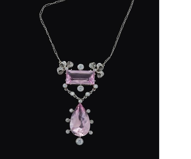 An Edwardian platinum pendant necklace with morganites and diamonds. The lavalier necklace has a rectangular-cut morganite with an approximate total weight of 3.50 carats, a pear-shape morganite with an approximate total weight of 10.50 carats, and