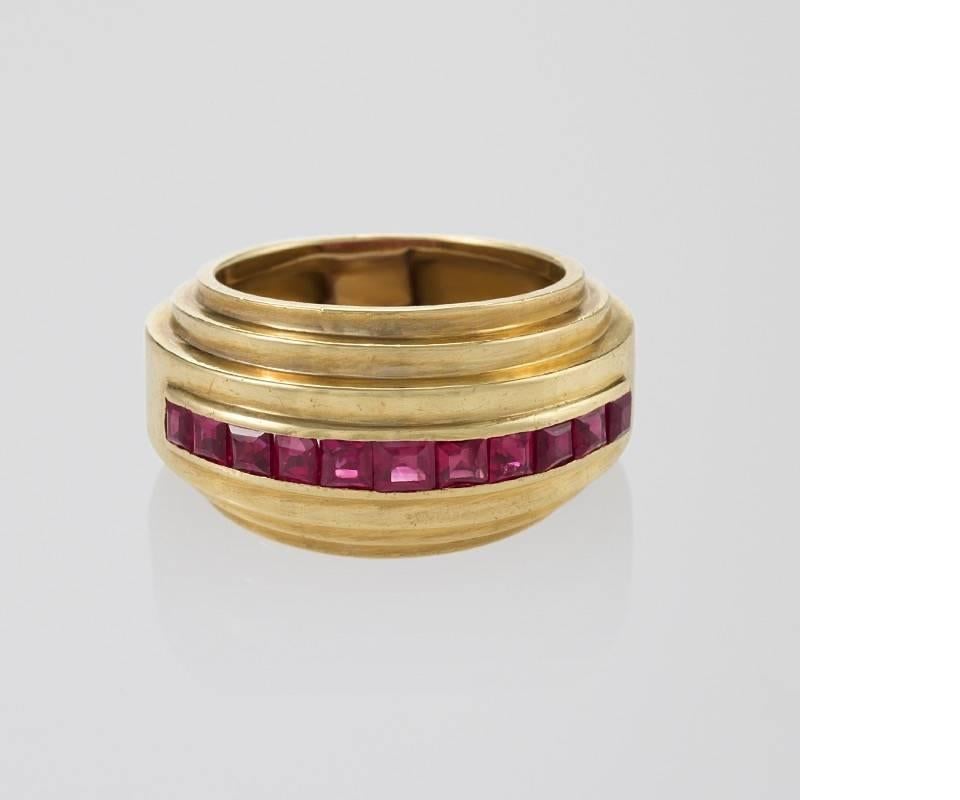 A French Art Deco 18 karat gold ring with rubies by Van Cleef & Arpels. The ring has 11 square-cut rubies with an approximate total weight of 1.32 carats. The ring is designed in a triple stepped, polished gold motif. Circa 1930's. 

Similar
