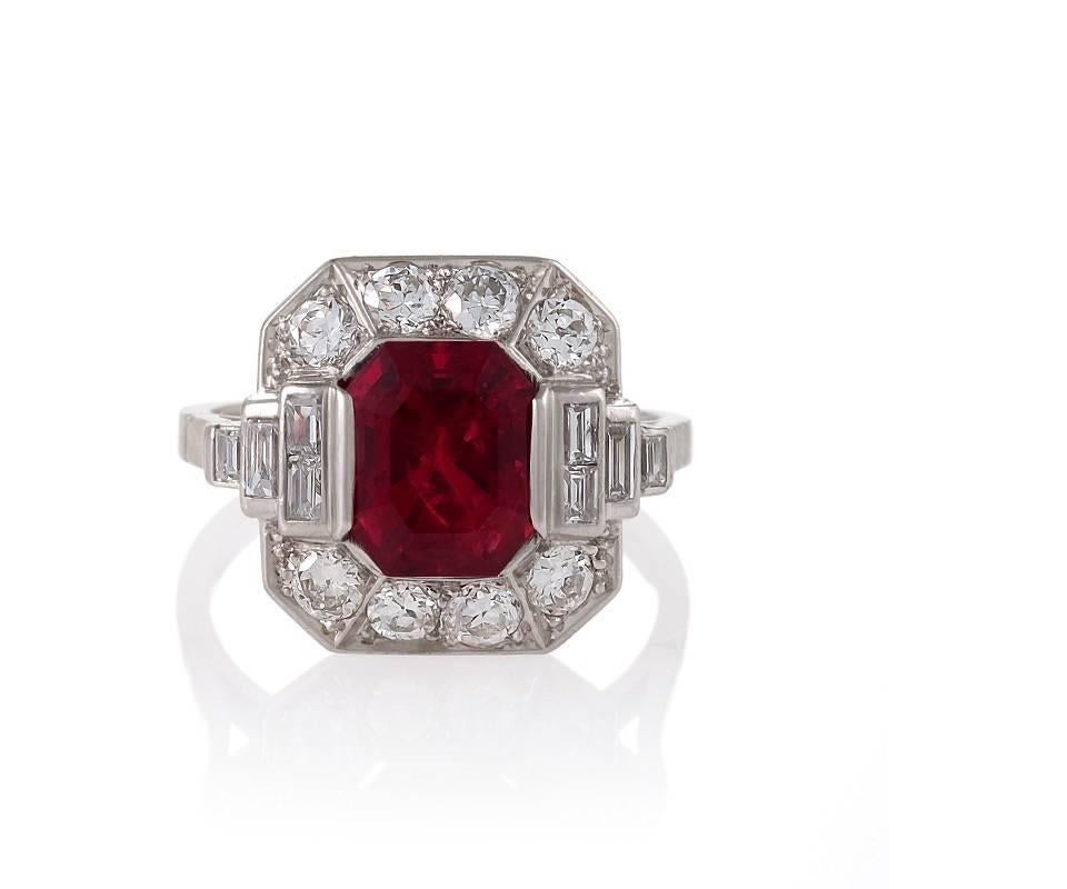 A French Art Deco ring with red spinel and diamonds. The ring has a rectangular-cut red spinel with an approximate weight of 3.29 carats, 8 old European-cut diamonds with an approximate total weight of .64 carat, and 8 baguette diamonds with an