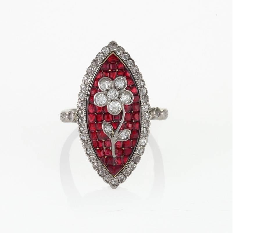 An Edwardian platinum and 18 karat gold ring with rubies and diamonds. The ring has 52 square-cut rubies with an approximate total weight of 1.65 carats, and 46 round diamonds with an approximate total weight of .75 carat.  The Navette shaped ring