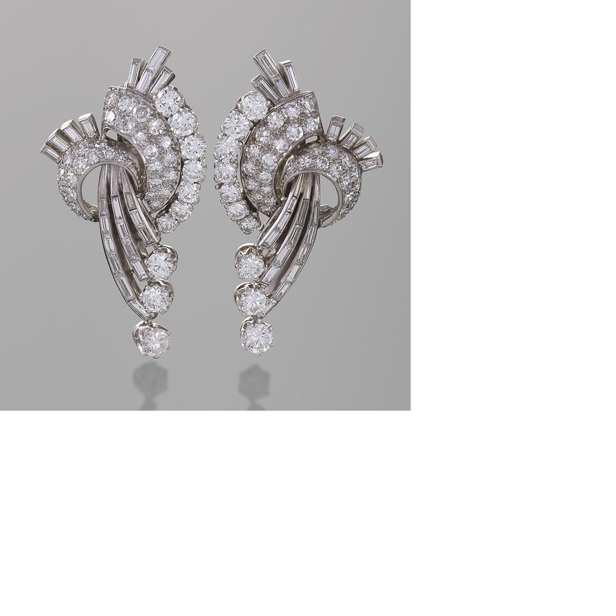 A pair of French Mid-20th Century platinum earrings with diamonds. The earrings have 82 round-cut diamonds with an approximate total weight of 4.20 carats, and 48 baguette diamonds with an approximate total weight of 3.00 carats, H/I color, VS