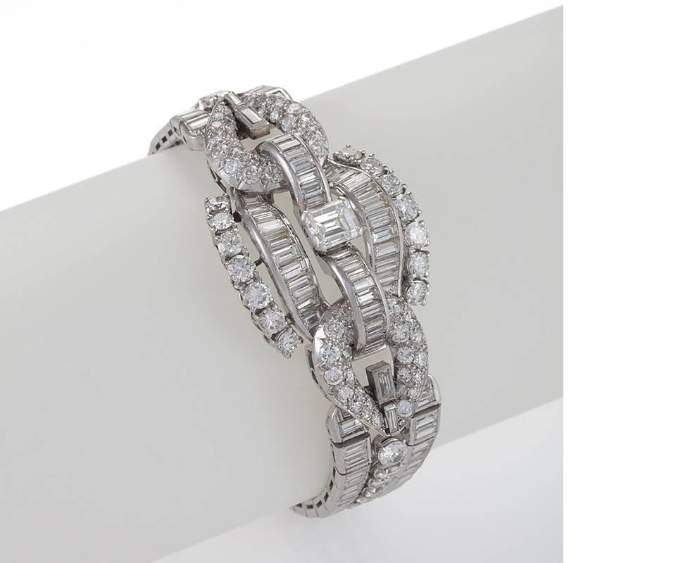 The design of this scintillating diamond link bracelet from the mid-20th century descends from the conventions of the finest European regalia. The flexible platinum jewel drapes elegantly on the wrist, featuring an interlocking harness motif