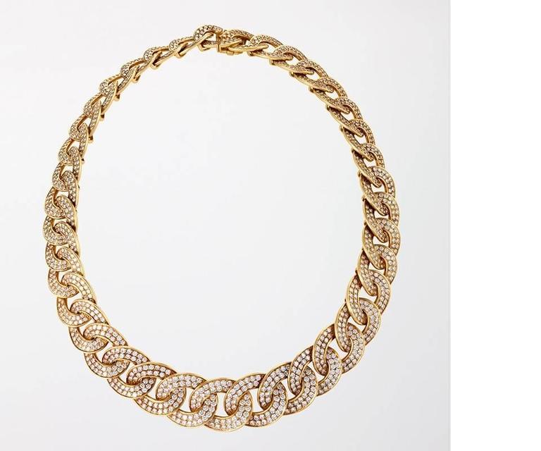 This gently twisted and graduated curb link necklace, consisting of thirty-seven links pavé-set with nearly fifty carats of round brilliant-cut diamonds in gold, is a classic design of the 1980s from Van Cleef & Arpels, executed by one of Paris’s