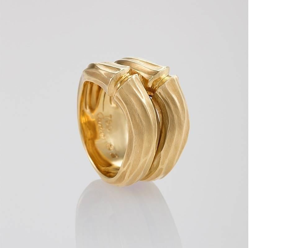 A French Estate 18 karat gold ring by Cartier. The ring is the classic “Bamboo” double band ring. Circa Estate. 

Signed, “750 Cartier 52” “758821” French maker’s mark. 

Size: 6; can be sized.

(MG #16911)