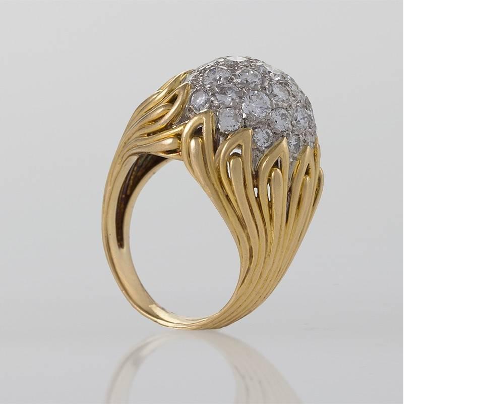 A French Mid-20th Century 18 karat gold ring with diamonds by Van Cleef & Arpels. The ring has 31 round diamonds with an approximate total weight of 2.48 carats. The ring is composed in a modernist flame motif which centers on the diamond set bombé