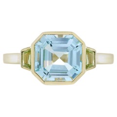 Blue Topaz Peridot Solitaire Ring in 9K Yellow Gold