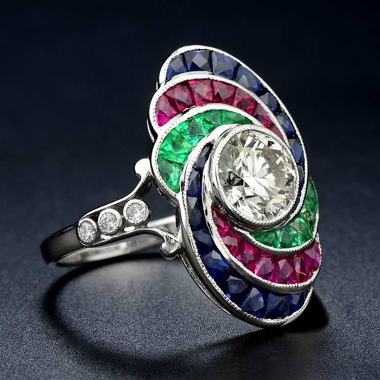 Art Deco style ring from 1920's set with center GIA Certified 1.21 Carat  Diamond (M color VVS2 clarity) #2224686269 and 2.95 Carat of color stones (Emerald, Ruby and Sapphire).  Also, there is another 0.09 ct. small diamonds on the sides.  

The